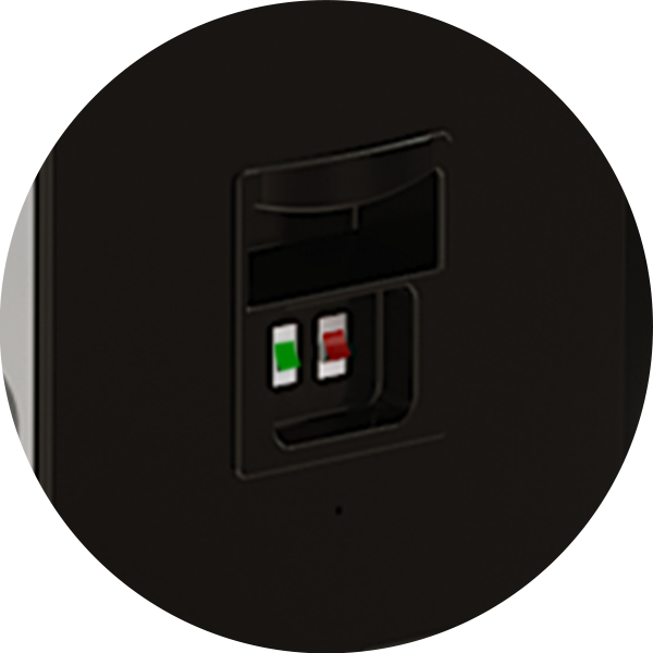 Close-up of a black speaker terminal with spring clips, featuring one red and one green connector for speaker wire attachment.
